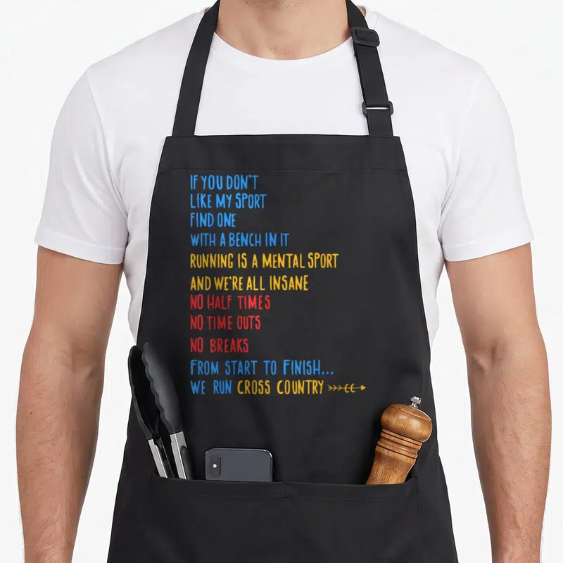 Run country apron - Stacked blue yellow and red running quote typography with arrows — shown on a black cotton canvas apron against a white background