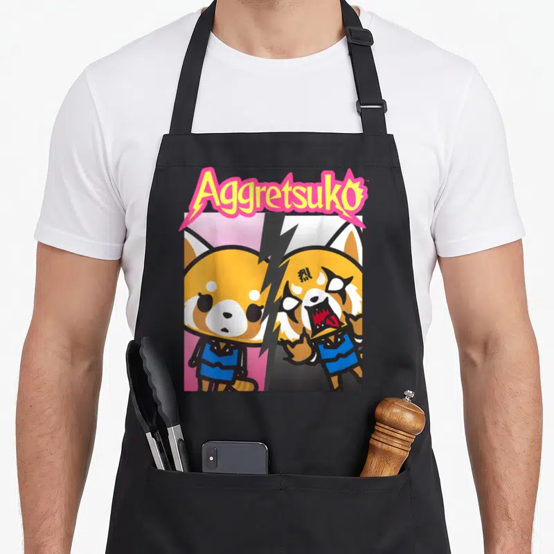 Personality split apron - Arched Aggretsuko text over split calm and angry red panda in cartoon style with lightning — shown on a black cotton canvas apron against a white background