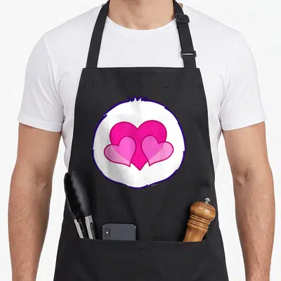 Harmony halloween apron - Three pink hearts in a white circle with a purple outline — shown on a black cotton canvas apron against a white background
