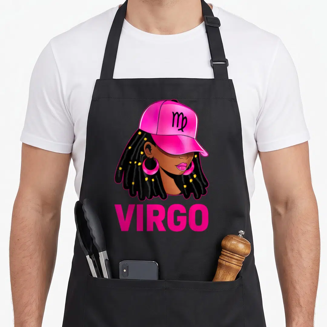 Virgo hair apron - Stylized woman in pink cap with black braids and gold beads below pink VIRGO text — shown on a black cotton canvas apron against a white background