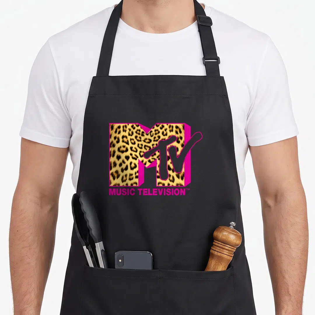 Mtv leopard apron - MTV logo with leopard print fill, pink outline, and MUSIC TELEVISION text below — shown on a black cotton canvas apron against a white background