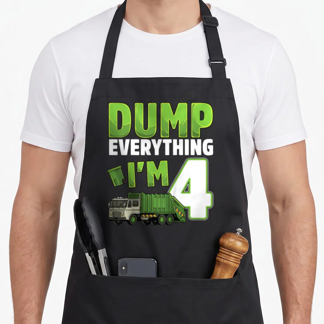 Garbage 4th truck apron - Green and white DUMP EVERYTHING I'M 4 text with cartoon truck and trash can — shown on a black cotton canvas apron against a white background