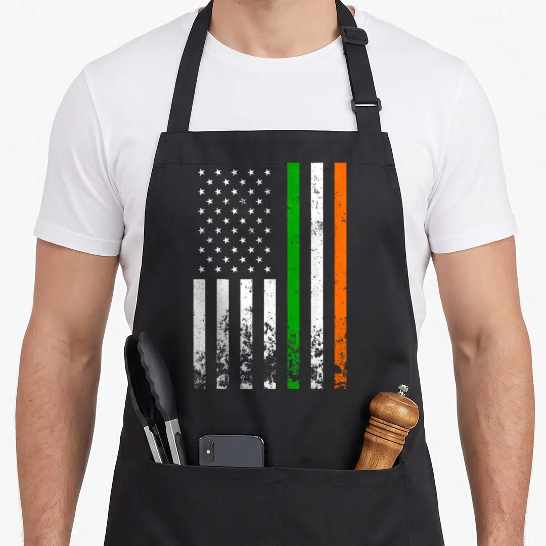 Irish ireland apron - Distressed flag print with white stars on left and vertical green white orange stripes on right — shown on a black cotton canvas apron against a white background