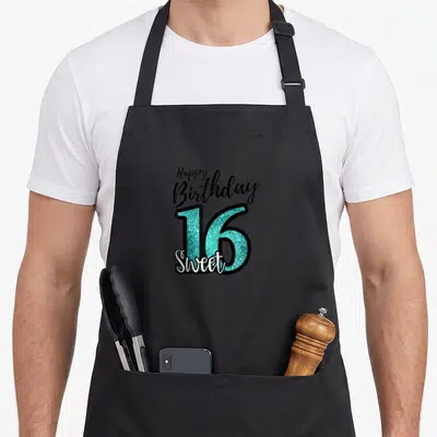 Turquoise birthday apron - Stacked Happy Birthday 16 Sweet text in black turquoise and white — shown on a black cotton canvas apron against a white background