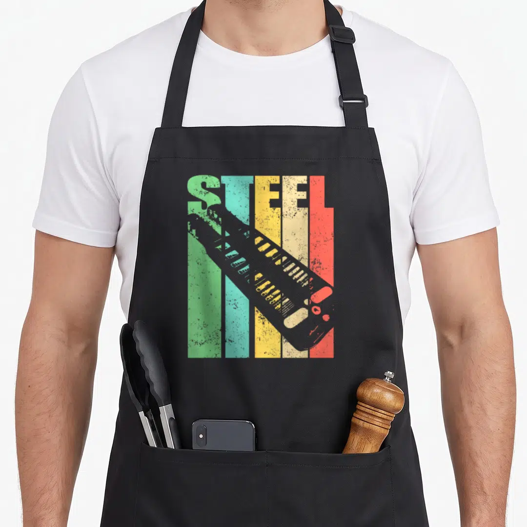 Lap classic rock apron - Retro STEEL text over green teal yellow red grey stripes with diagonal grey boot silhouette — shown on a black cotton canvas apron against a white background