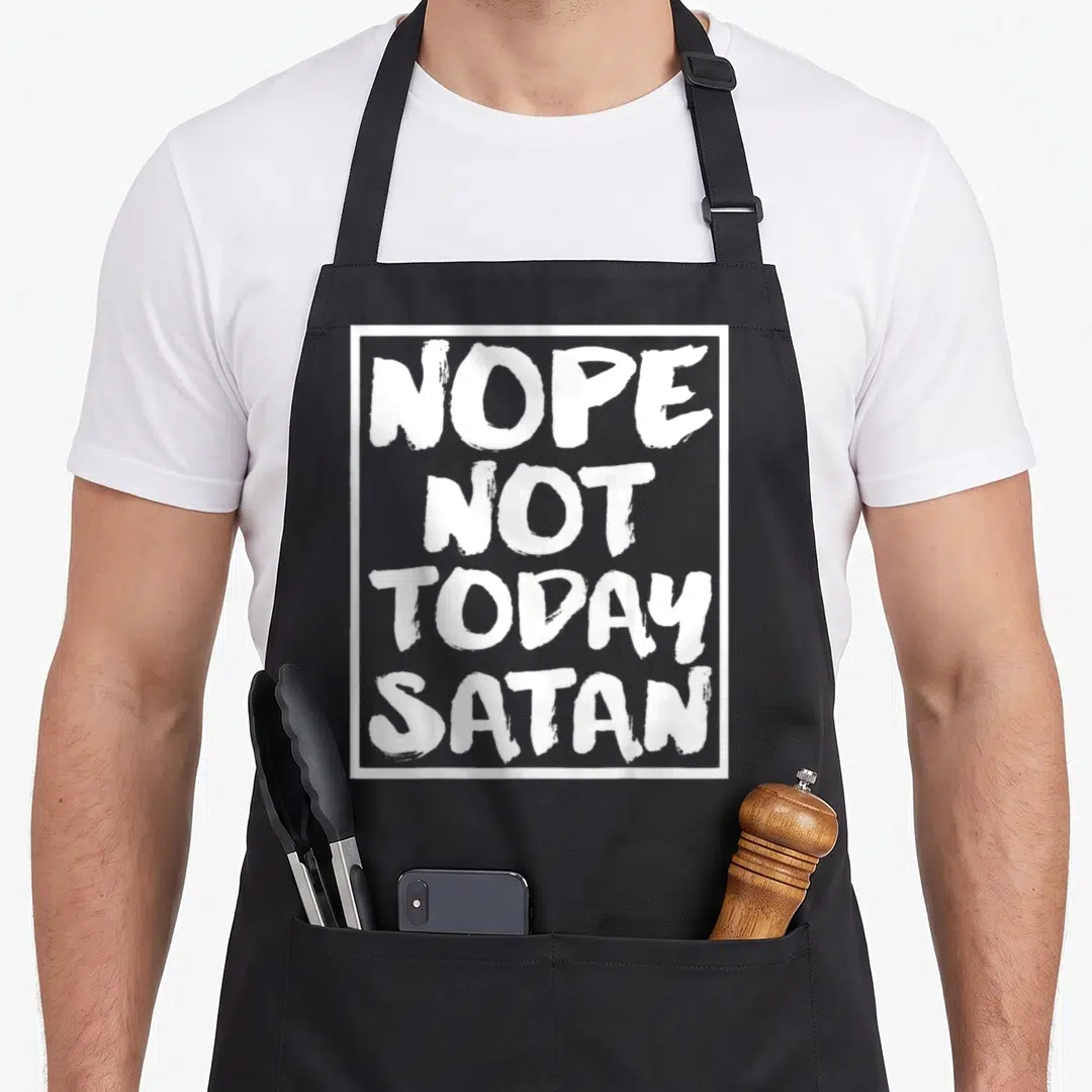 Nope christian apron - White stacked text reading NOPE NOT TODAY SATAN inside a rectangular border — shown on a black cotton canvas apron against a white background