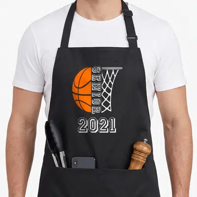Graduate senior class player apron - Orange basketball next to vertical white SENIOR text and net above 2021 — shown on a black cotton canvas apron against a white background