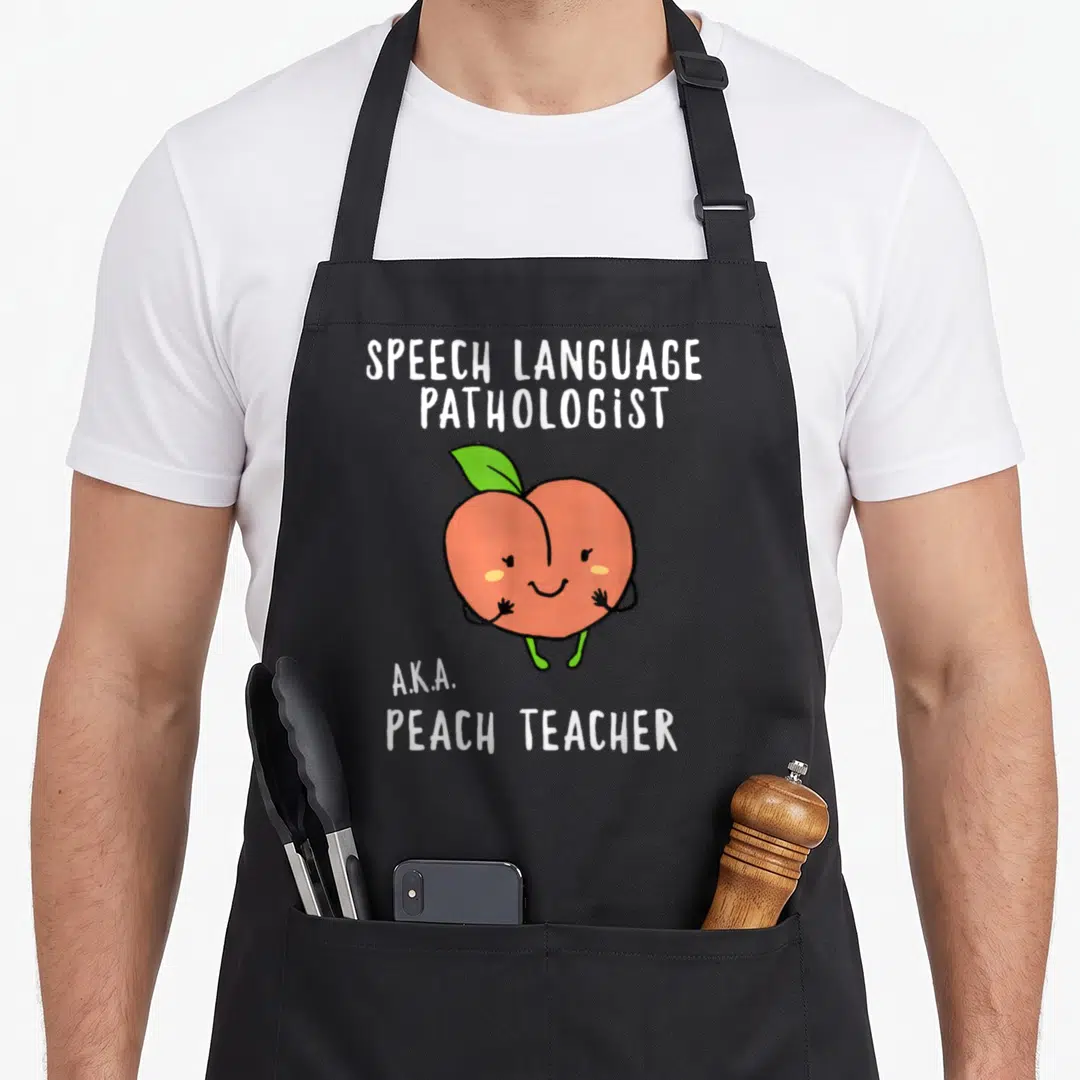 Speech teacher apron - Cartoon orange peach with green leaf and white text reading Speech Language Pathologist AKA — shown on a black cotton canvas apron against a white background