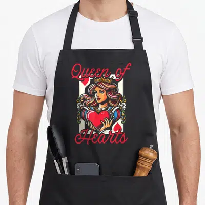 Passion queen apron - Cartoon Queen of Hearts holding red heart on white card background with red script text — shown on a black cotton canvas apron against a white background