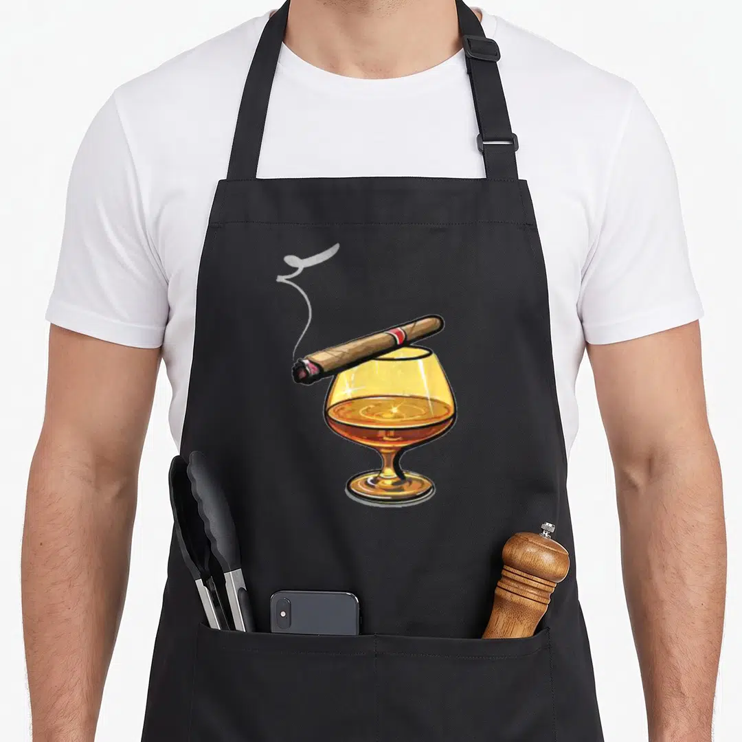 Smoke scotch apron - Amber brandy glass with brown cigar and grey smoke wisp realistic print — shown on a black cotton canvas apron against a white background