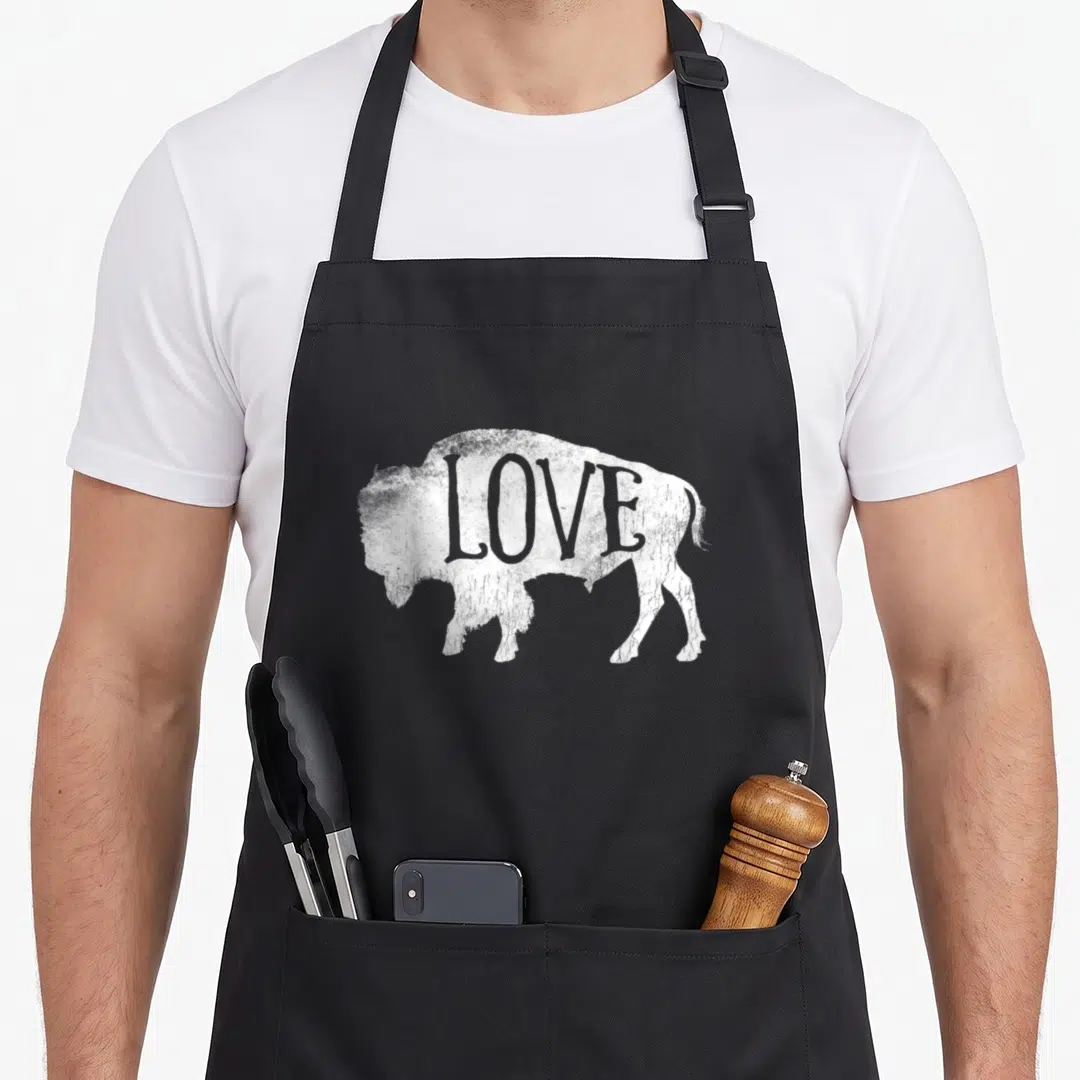 Silhouette buffalo apron - Distressed white bison silhouette with the word love printed inside the body — shown on a black cotton canvas apron against a white background