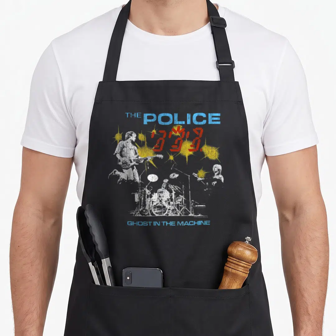 Rock police apron - Distressed white band silhouettes with blue text and yellow red splatters — shown on a black cotton canvas apron against a white background