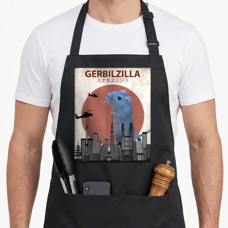 Gerbilzilla i love my gerbil apron - Giant blue gerbil behind grey city skyline in front of red sun with two black — shown on a black cotton canvas apron against a white background