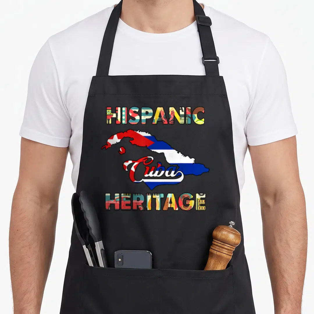 Cuba heritage hispanic aprons - Map of Cuba with red blue white yellow green flag fill and HISPANIC HERITAGE text — shown on a black cotton canvas apron against a white background