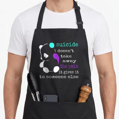 Suicide depression awareness apron - White panda graphic with cyan circle and purple semicolon shape next to stacked — shown on a black cotton canvas apron against a white background