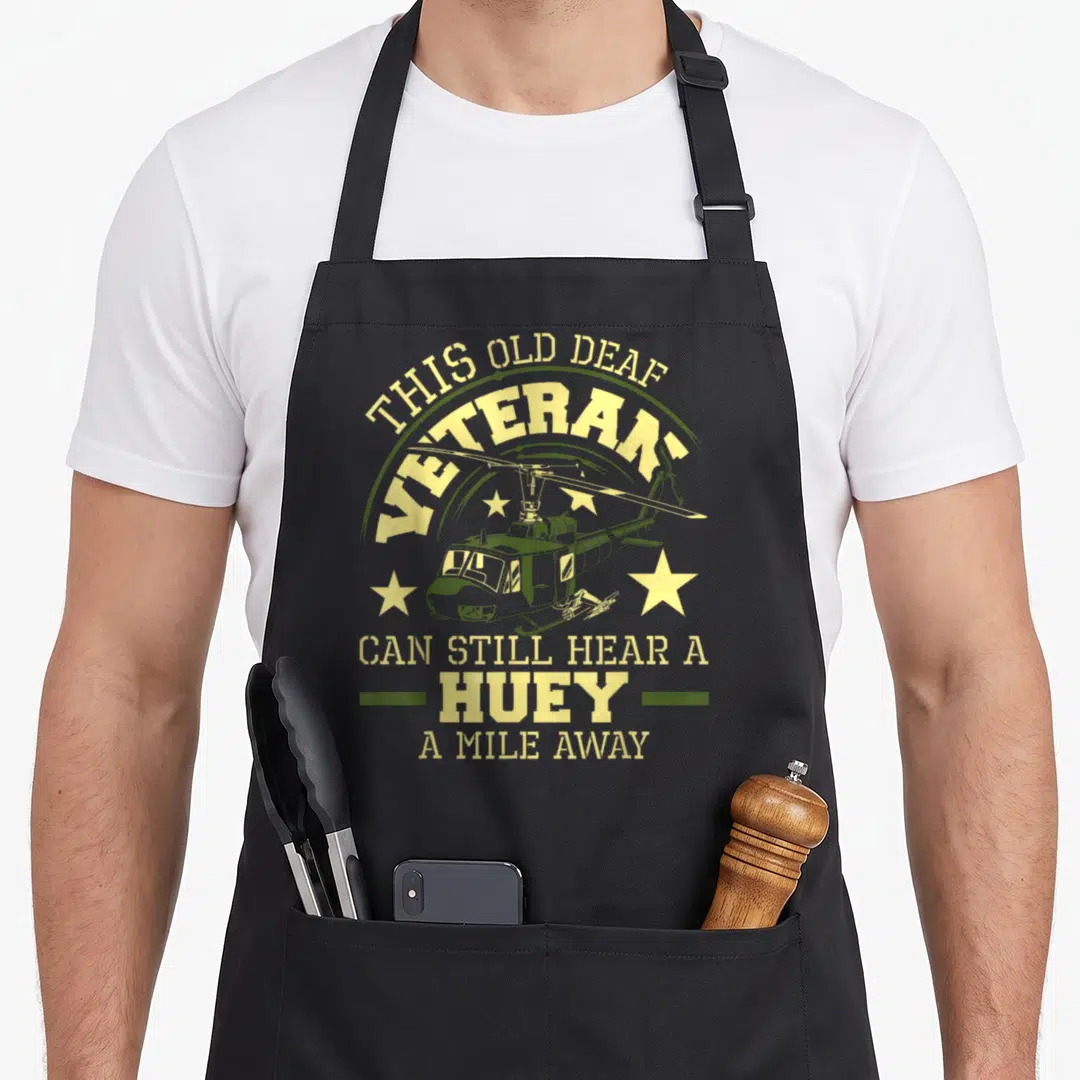 Hear vulture dad apron - Distressed olive and yellow helicopter graphic with stars and arched text reading This Old — shown on a black cotton canvas apron against a white background