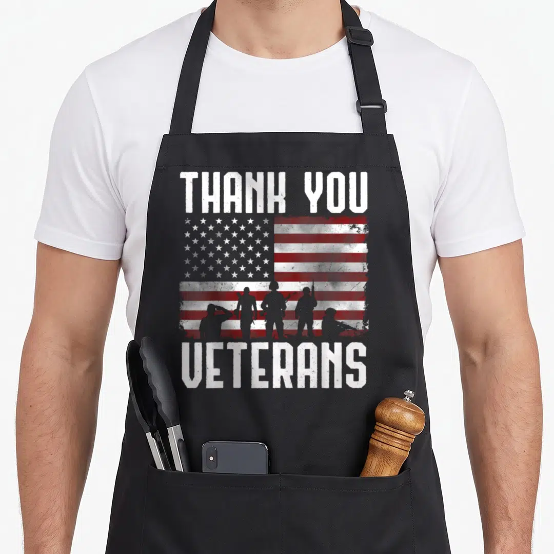 Thank veterans day apron - Distressed USA flag with five soldier silhouettes and white text reading THANK YOU VETERANS — shown on a black cotton canvas apron against a white background