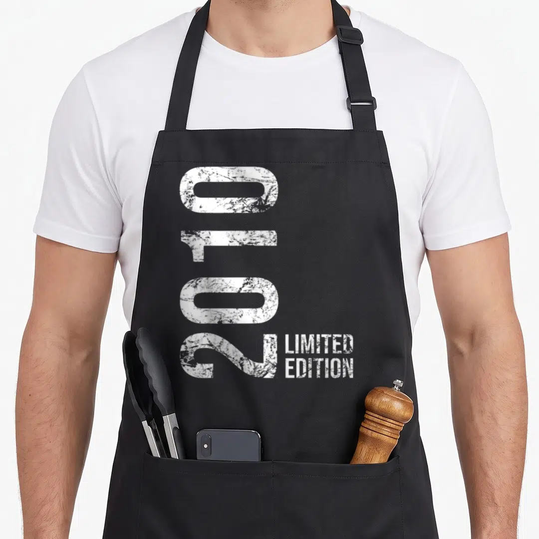 Limited 16th birthday apron - White 2010 numbers rotated vertically beside Limited Edition text on grey background — shown on a black cotton canvas apron against a white background