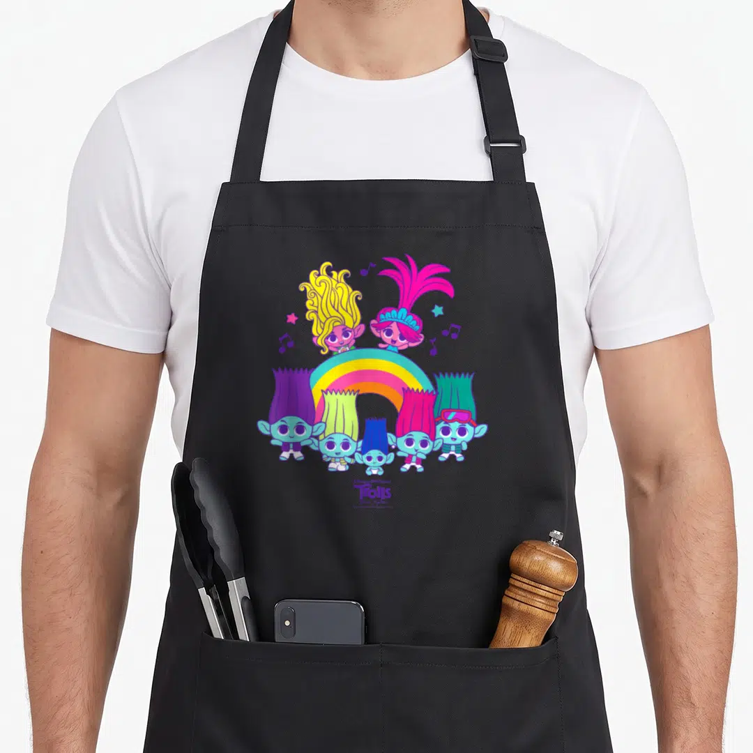 Band rainbow apron - Seven cartoon trolls with colorful hair standing around a rainbow with Band Together text — shown on a black cotton canvas apron against a white background