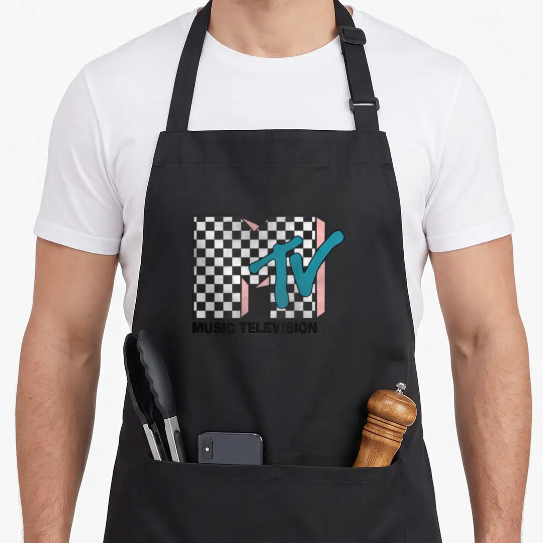 Mtv pink checkered apron - Checkerboard M logo with blue TV script and MUSIC TELEVISION text on black background — shown on a black cotton canvas apron against a white background
