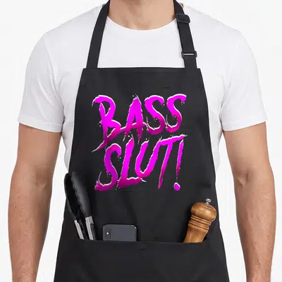 Bass dubstep apron - Pink and magenta BASS SLUT! typography with white outlines on black background — shown on a black cotton canvas apron against a white background