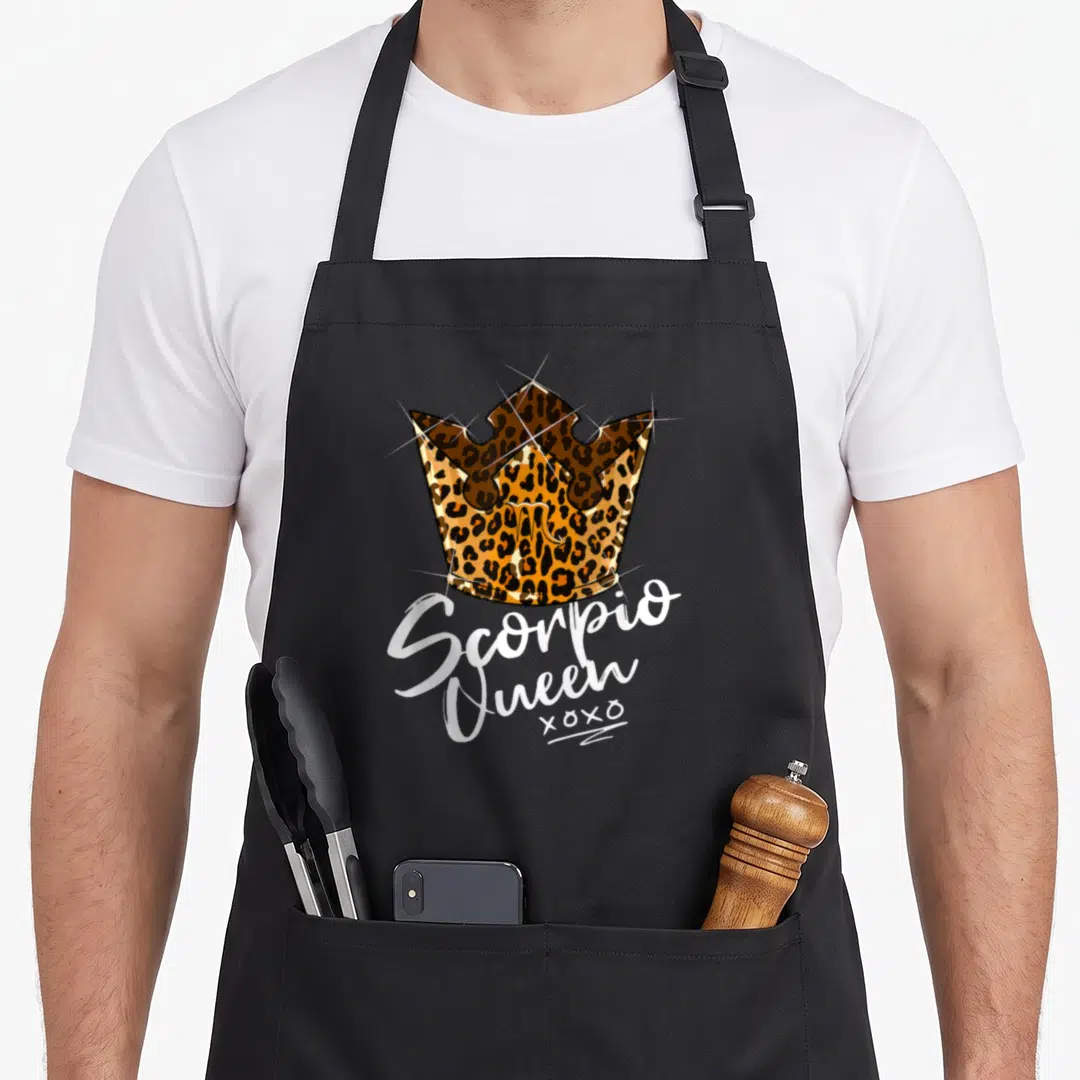 Scorpio leopard apron - Leopard print crown with Scorpio Queen xoxo text in white script — shown on a black cotton canvas apron against a white background