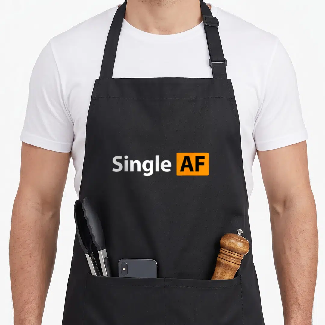 Proudly sarcastic apron - Single AF text with white letters and black AF inside orange rectangle — shown on a black cotton canvas apron against a white background