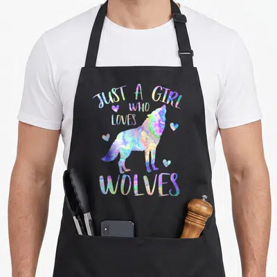 Cute wolf wolves apron - Watercolor wolf with hearts and text Just a Girl Who Loves Wolves — shown on a black cotton canvas apron against a white background
