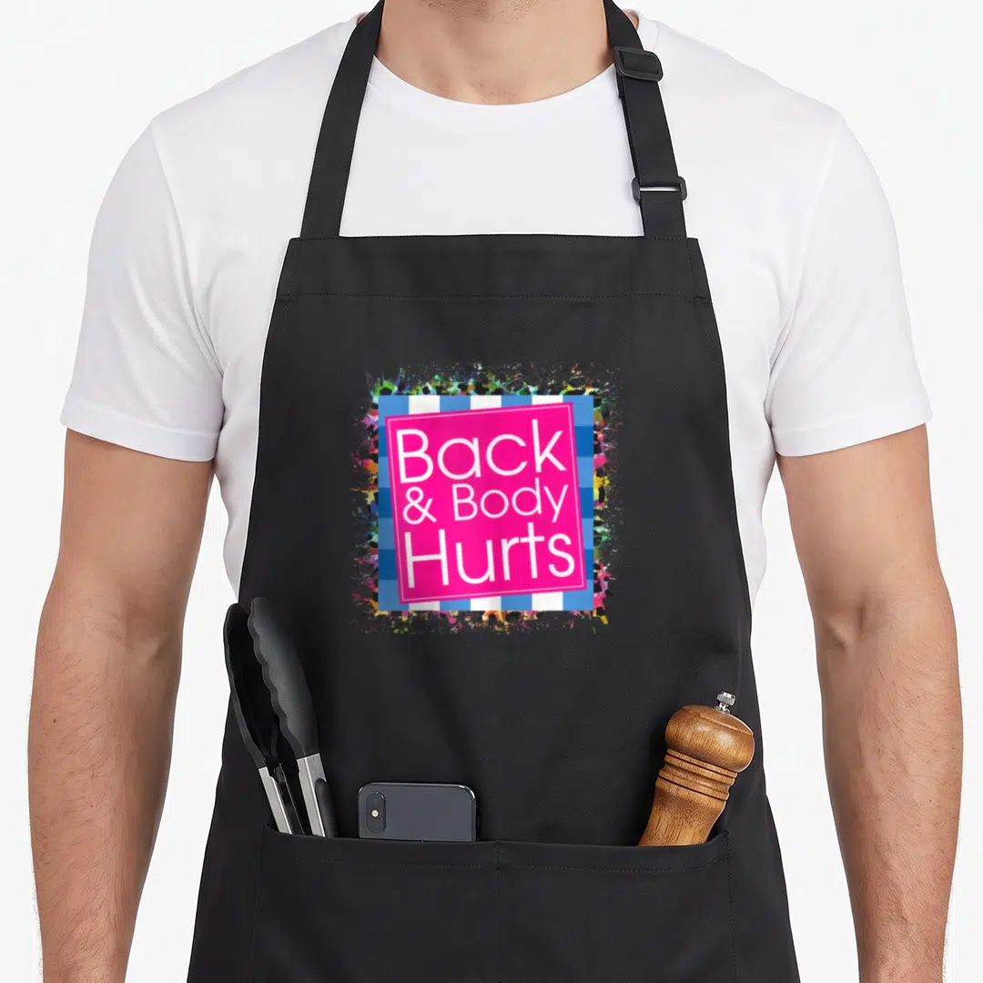 Hurt body apron - Stacked white text Back Body Hurts on pink square over blue striped background with paint splatters — shown on a black cotton canvas apron against a white background