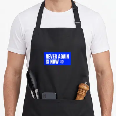 Pride jewish apron - Blue rectangle with white NEVER AGAIN IS NOW text and Star of David symbol — shown on a black cotton canvas apron against a white background