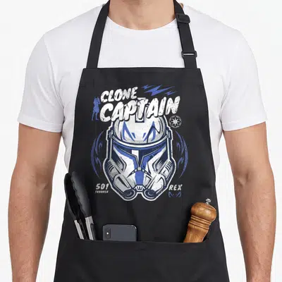 Clone t-rex apron - Distressed Clone Captain helmet with 501 Trooper REX text and blue lightning bolts — shown on a black cotton canvas apron against a white background