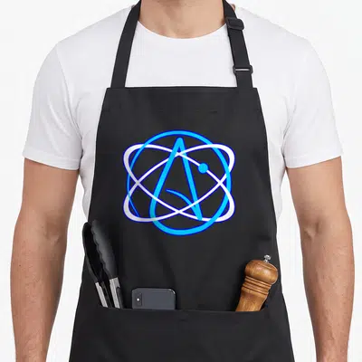 Symbol science apron - Blue and white atom symbol with letter A and electron orbit — shown on a black cotton canvas apron against a white background