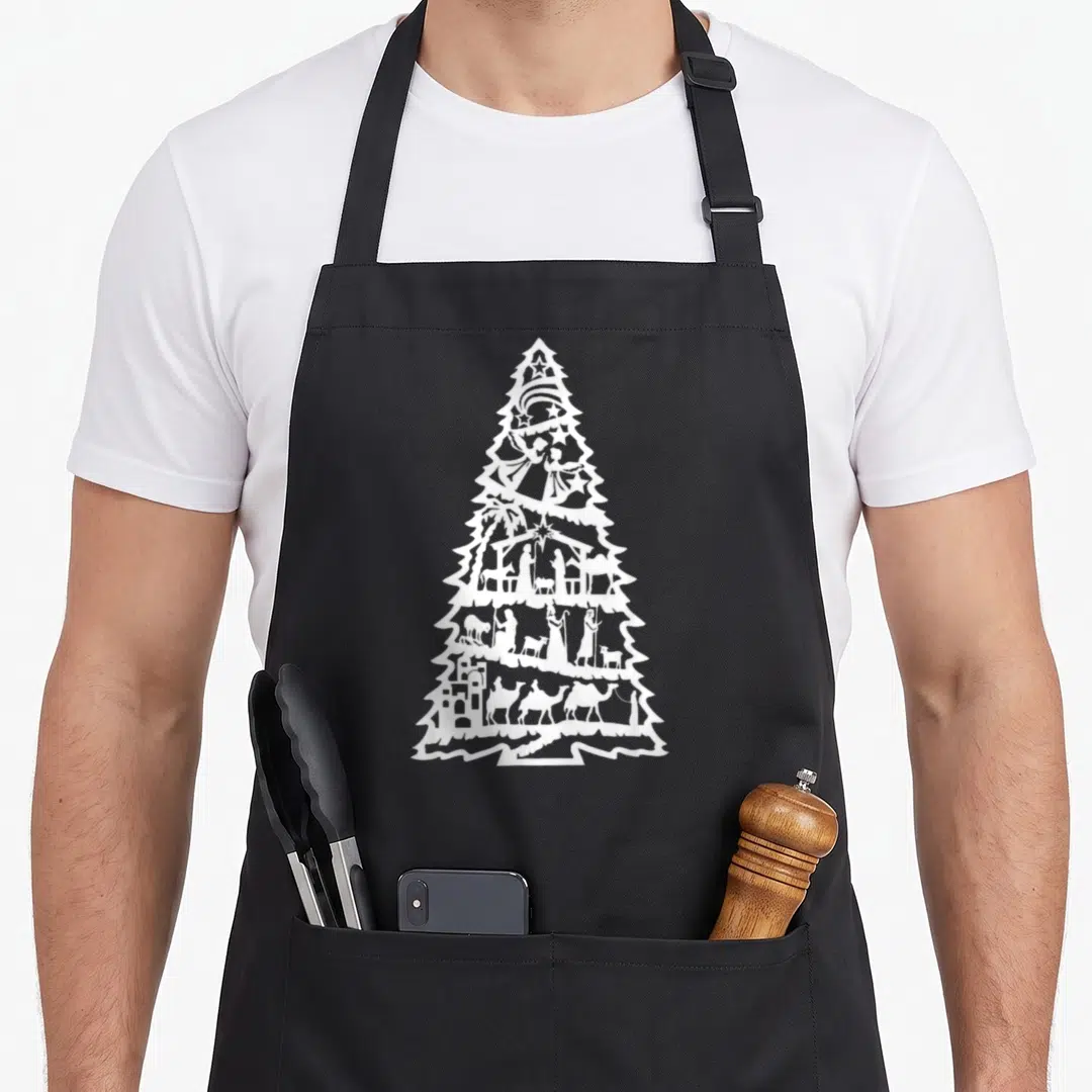 Nativity christmas tree apron - White Christmas tree silhouette containing multi-tiered nativity scene with star — shown on a black cotton canvas apron against a white background