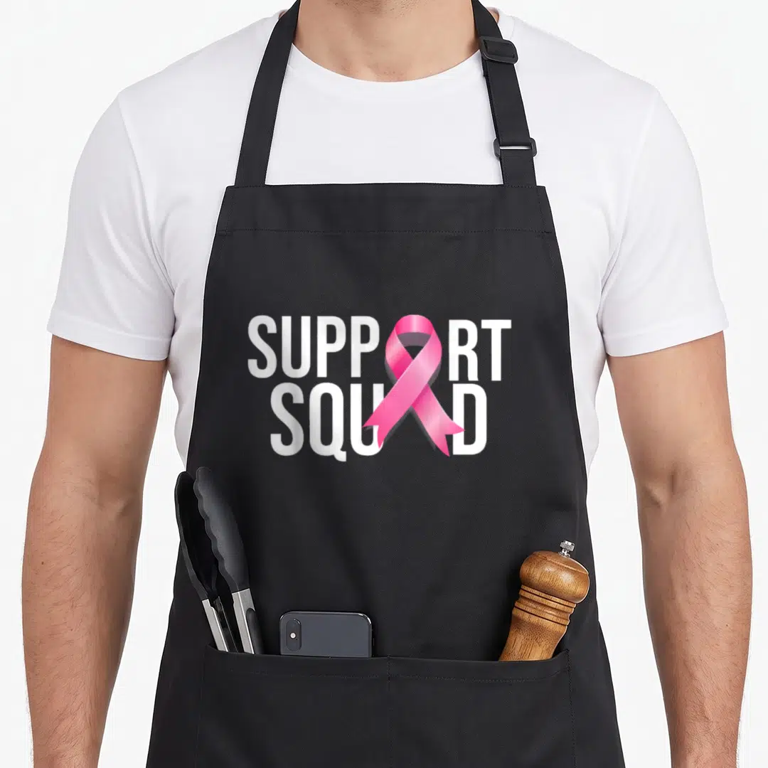Ribbon survivor breast cancer awareness aprons - White SUPPORT SQUAD text with a vertical pink awareness ribbon — shown on a black cotton canvas apron against a white background