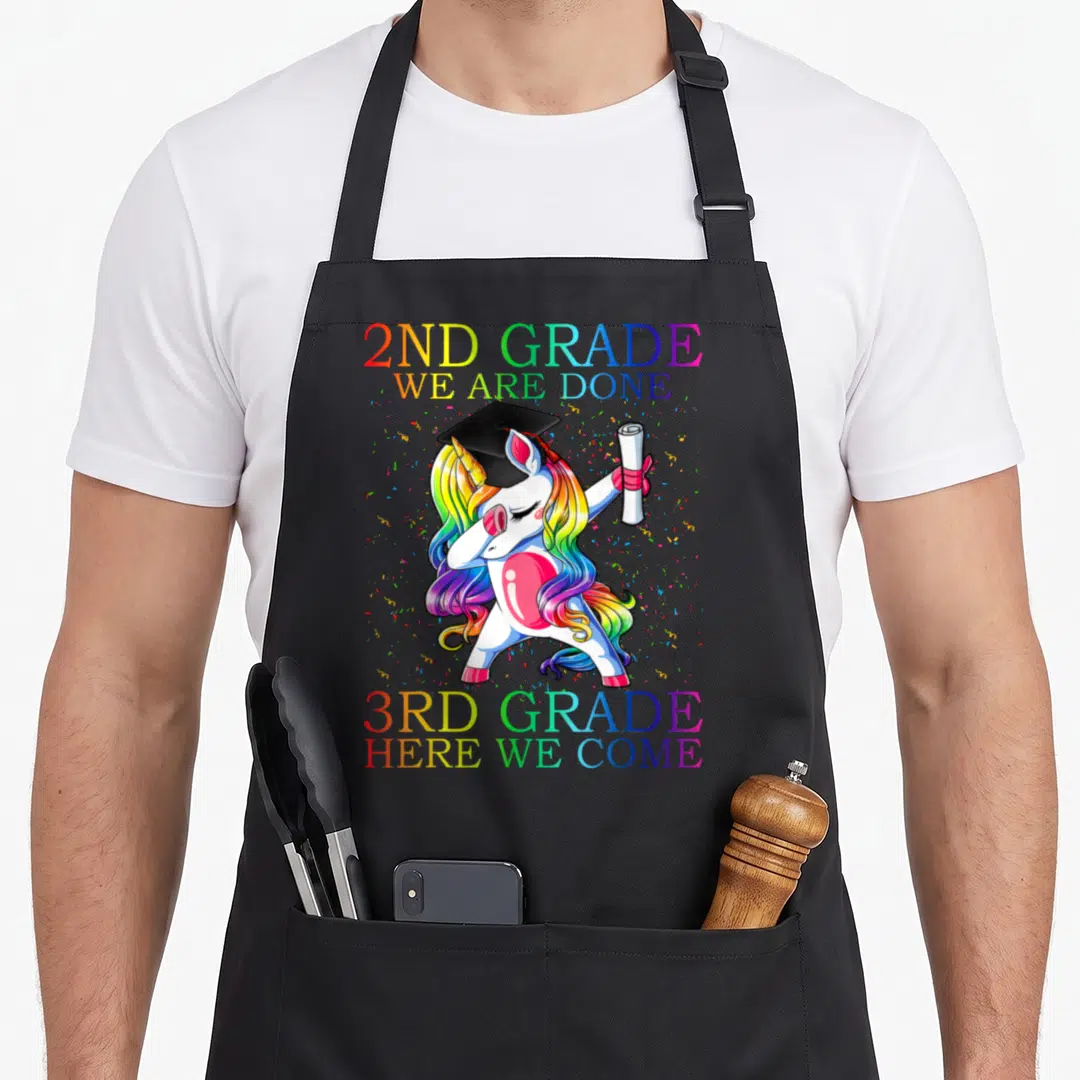3rd 2nd apron - Dabbing unicorn with rainbow mane holding diploma under 2nd grade done 3rd grade here we come text — shown on a black cotton canvas apron against a white background