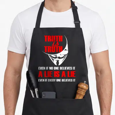 Mask hacker apron - Red and white Guy Fawkes mask with text about truth and lies on black background — shown on a black cotton canvas apron against a white background