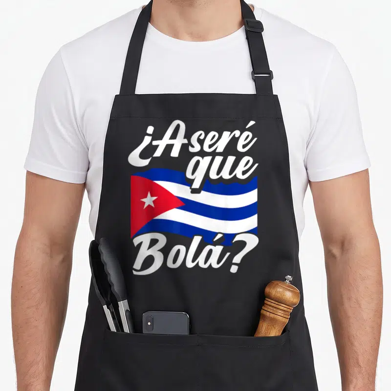 Asere cuban apron - Cuban flag in white blue red with ¿Aseré que Bolá? text above and below — shown on a black cotton canvas apron against a white background