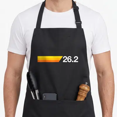 Marathoner marathon apron - White 26.2 text next to yellow orange gradient rectangle — shown on a black cotton canvas apron against a white background