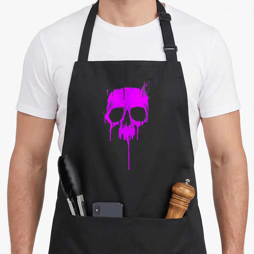 Hard paint apron - Purple distressed skull with dripping paint effects at the bottom — shown on a black cotton canvas apron against a white background