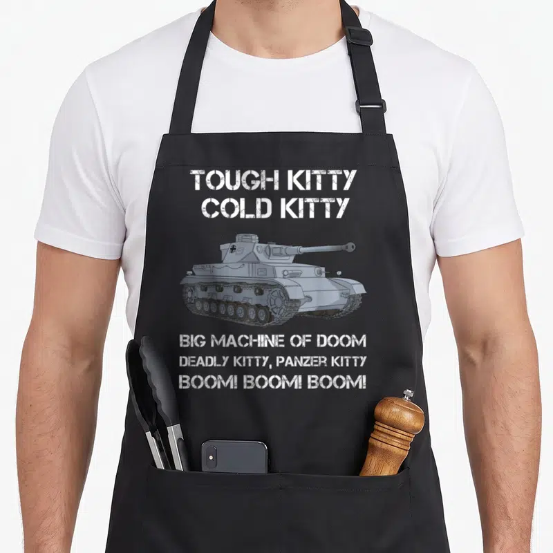 Panzer meme apron - Grey tank illustration surrounded by white stenciled text reading Tough Kitty Cold Kitty Big — shown on a black cotton canvas apron against a white background