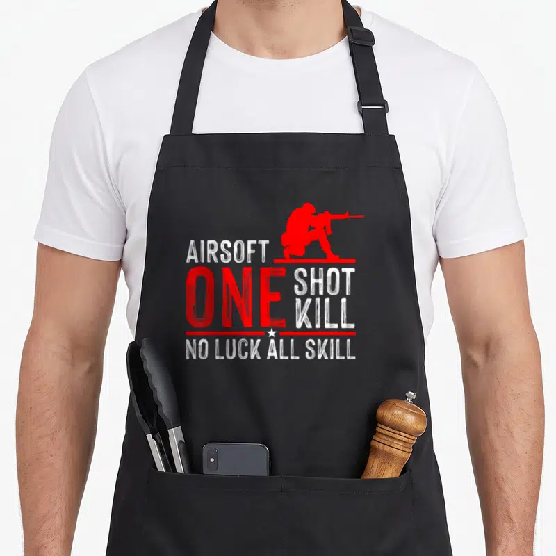 Sport gun apron - Red airsoft player silhouette with stacked text ONE SHOT KILL NO LUCK ALL SKILL in distressed font — shown on a black cotton canvas apron against a white background