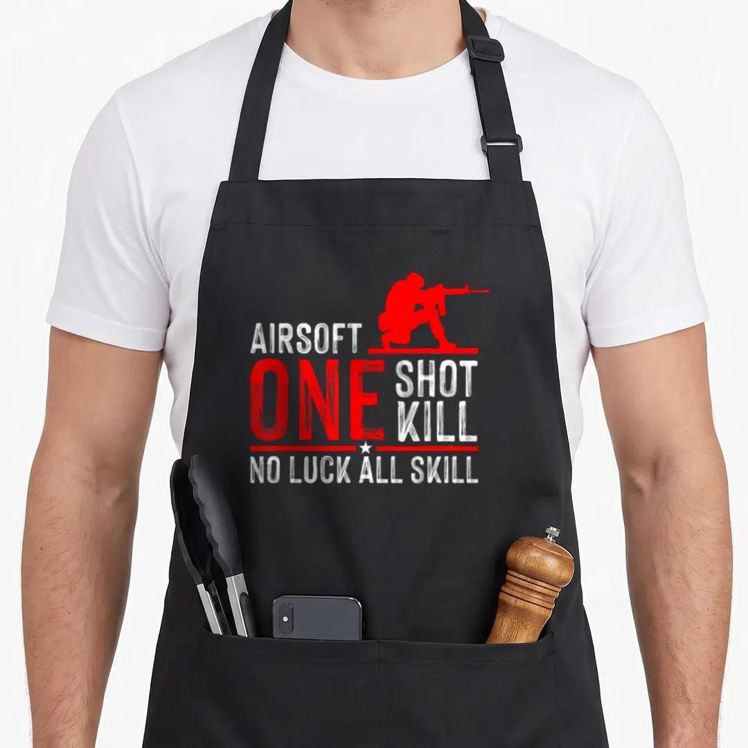 Sport gun apron - Red airsoft player silhouette with stacked text ONE SHOT KILL NO LUCK ALL SKILL in distressed font — shown on a black cotton canvas apron against a white background