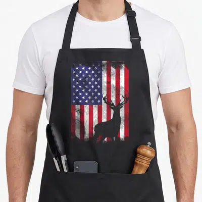 Deer elk american flag apron - Grey deer silhouette over distressed red white and blue American flag pattern — shown on a black cotton canvas apron against a white background