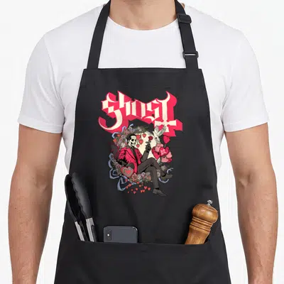 Ghost papa apron - Skeleton man in red suit holding rose among hearts and flowers under GHOST text — shown on a black cotton canvas apron against a white background