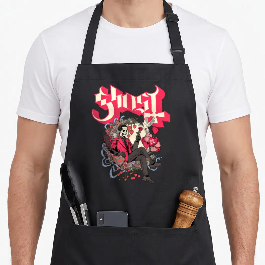 Ghost papa apron - Skeleton man in red suit holding rose among hearts and flowers under GHOST text — shown on a black cotton canvas apron against a white background