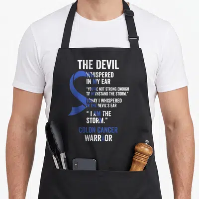 Colon devil's apron - The Devil Whispered In My Ear blue ribbon Colon Cancer Warrior typography design — shown on a black cotton canvas apron against a white background