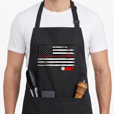 Emt line apron - Distressed black white flag with red heartbeat line and EMT Star of Life symbol — shown on a black cotton canvas apron against a white background