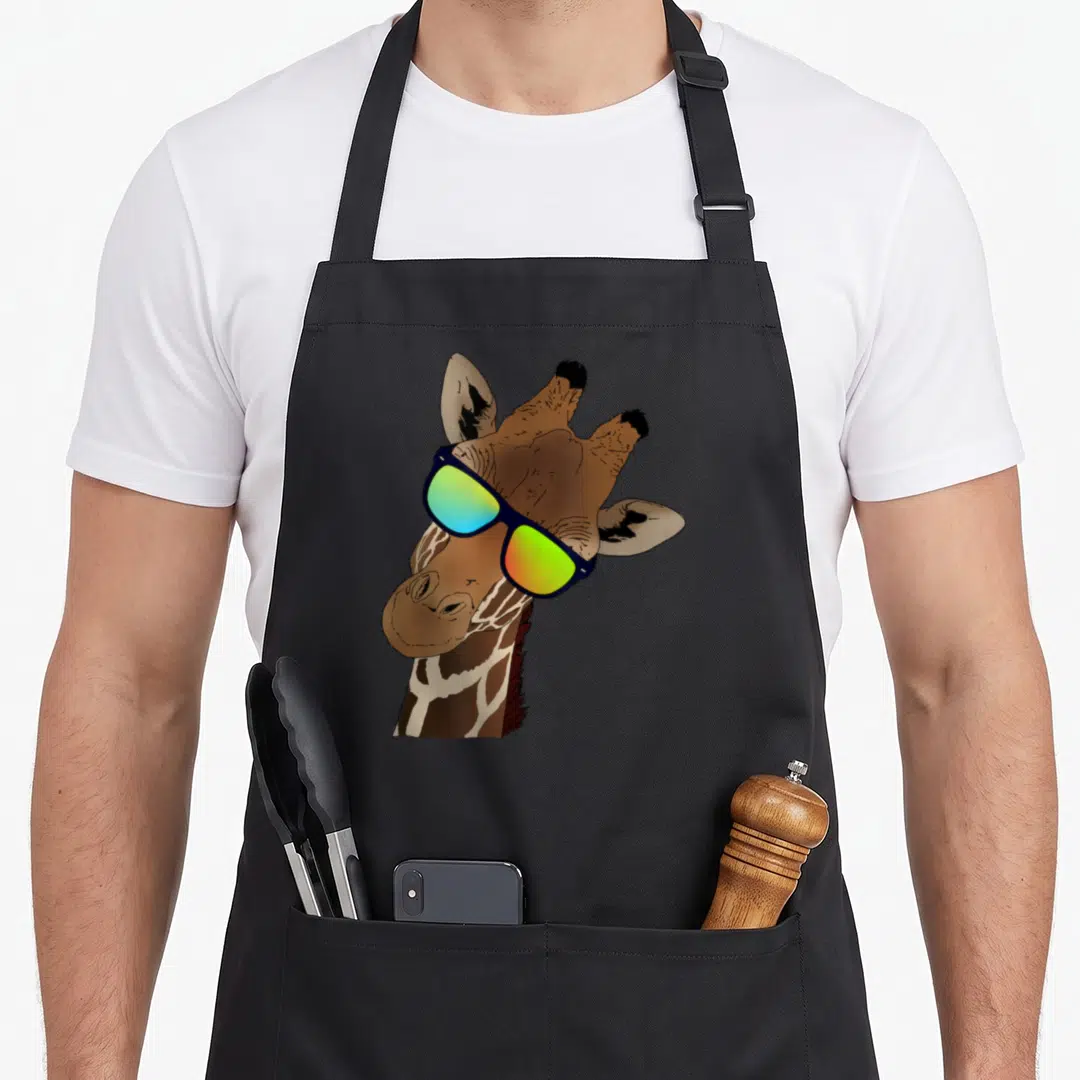 Zebras giraffe apron - Cartoon giraffe head wearing blue frame sunglasses with green and yellow lenses — shown on a black cotton canvas apron against a white background