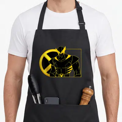 Funny portrait line apron - Minimalist black and yellow Wolverine portrait with X-Men logo circle and yellow — shown on a black cotton canvas apron against a white background