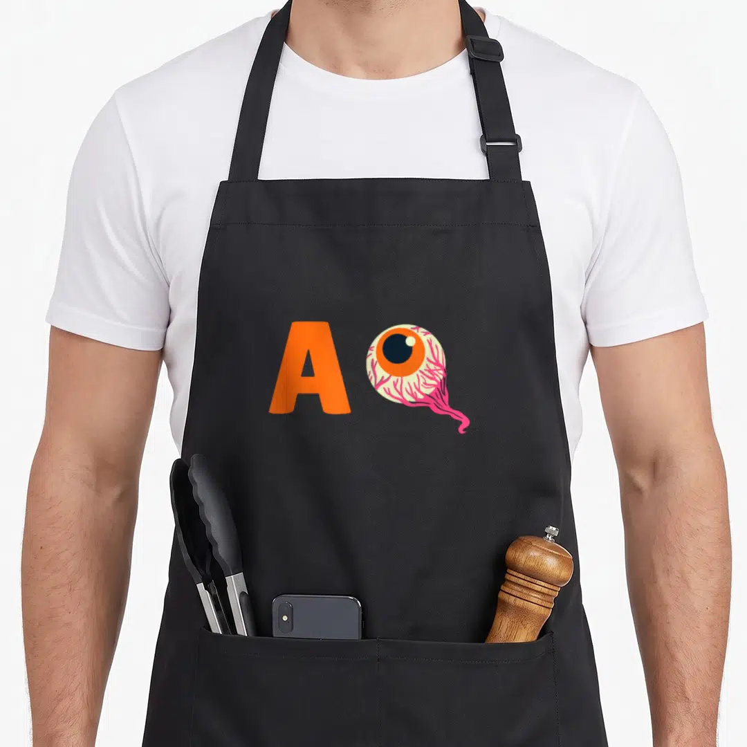 Easy costume halloween apron - Orange letter A beside a bloodshot eyeball with pink veins and orange iris, cartoon style — shown on a black cotton canvas apron against a white background